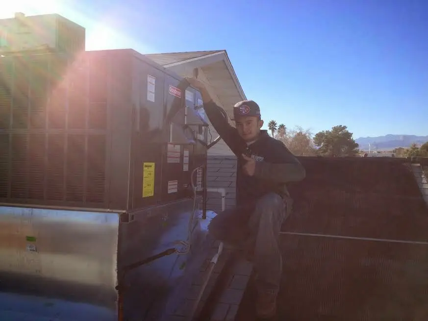 HVAC technician performing HVAC Inspection on a rooftop unit in Vine Grove